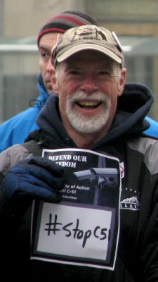 Oz Cole-Arnal holding a "Stop C51" sign